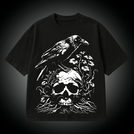 Black t-shirt with a white graphic of a raven on a skull and flowers on a dark background